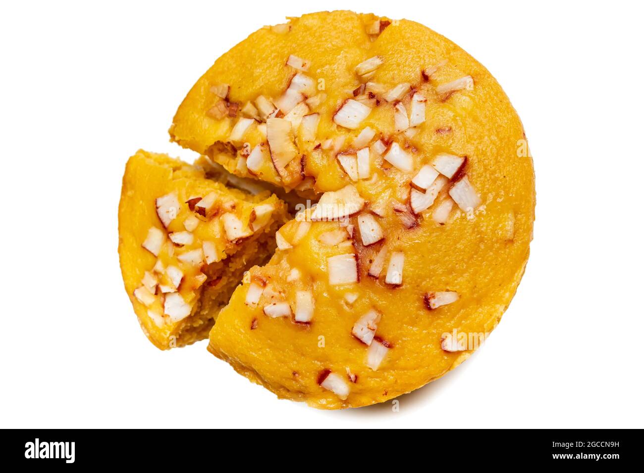 A large-sized ripe palmyra palm fruit cake sprinkled with coconut pieces. Steamed palmyra palm cake in isolated white background. Stock Photo