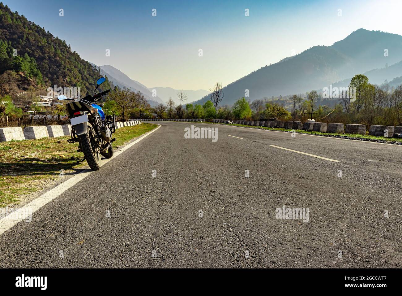 motorcycle at tarmac road with beautiful natural view at morning image is taken at shergaon arunachal pradesh india. Stock Photo