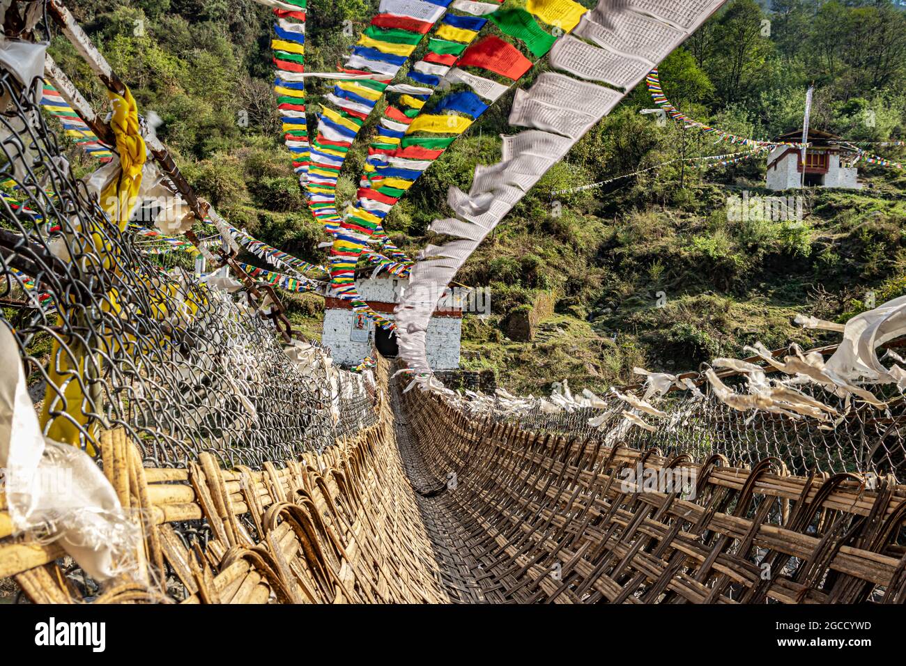 ancient holy bamboo bridge with many buddhist holy flags from unique perspective image is taken at chaksam bridge tawang arunachal pradesh india. Stock Photo