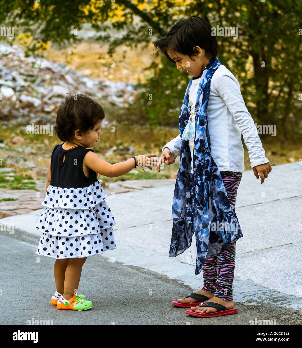 portrait of indian cute innocent friends shaking hand. Stock Photo