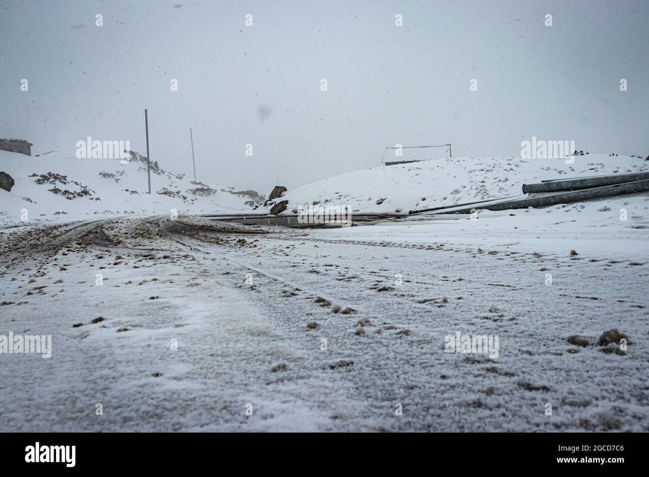 road covered with fresh snowfall at morning image is taken at madhuri lake tawang arunachal pradesh. Stock Photo