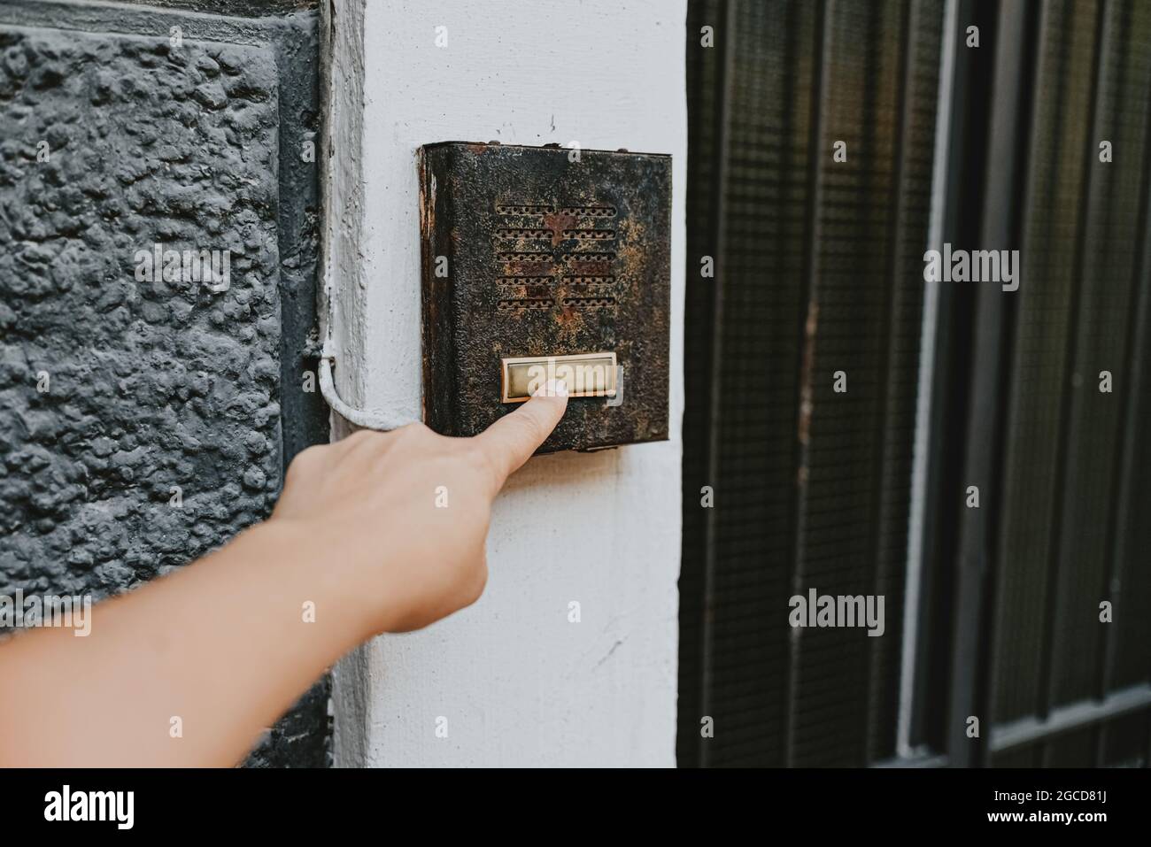 finger ringing a door bell Stock Photo