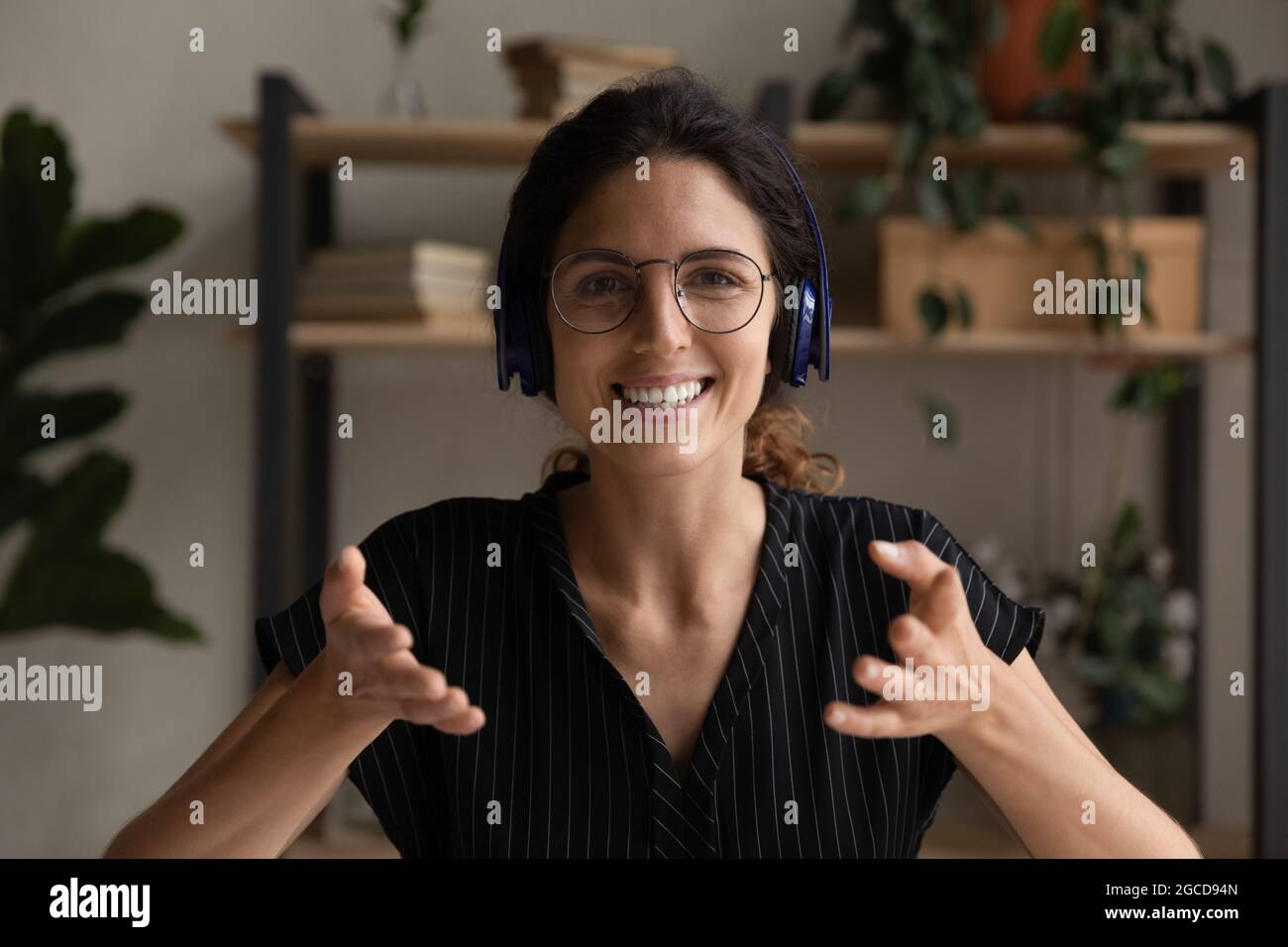 Head shot portrait of smiling woman in headphones speaking Stock Photo ...
