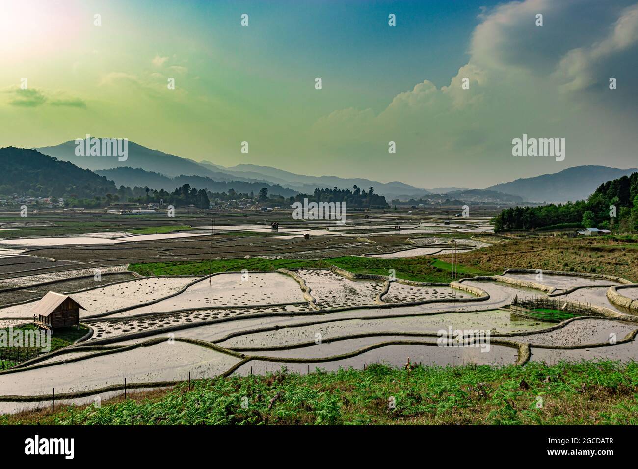 countryside tarnish framing rice field with small resting huts and