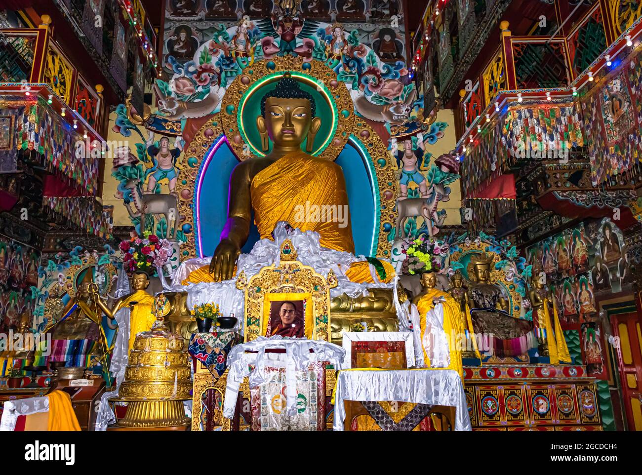 huge buddha golden statue decorated with religious flags and offerings at evening image is taken at tawang monastery arunachal pradesh india. Stock Photo