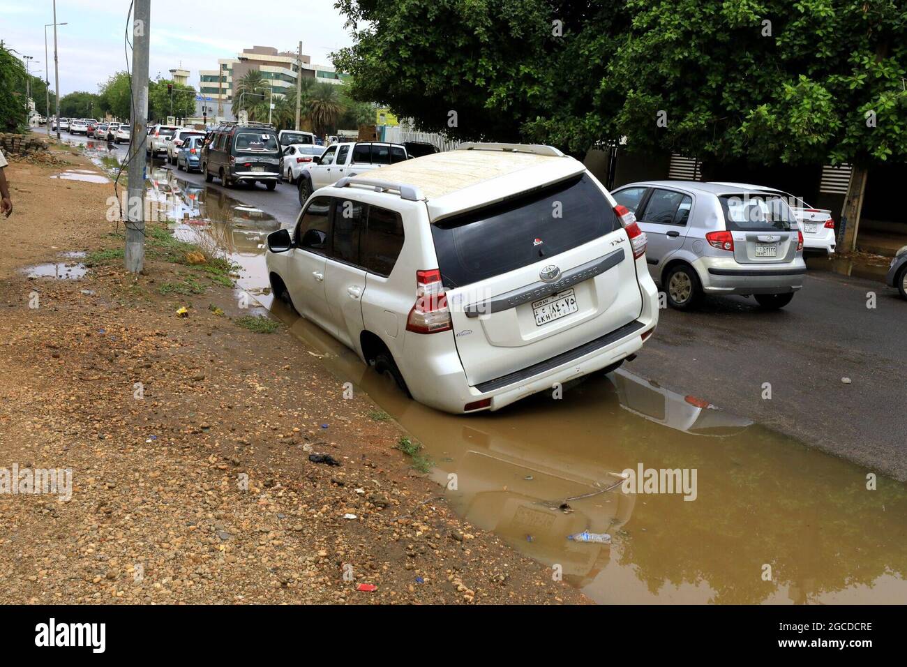 Khartoum, Sudan. 8th Aug, 2021. A car is seen trapped on a muddy side of the road after heavy rain hit Khartoum, Sudan, Aug. 8, 2021. Credit: Mohamed Khidir/Xinhua/Alamy Live News Stock Photo