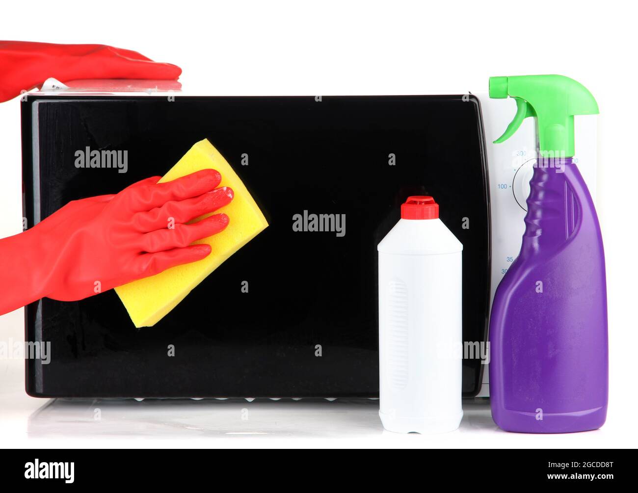 Hand with sponge cleaning microwave oven, isolated on white Stock Photo