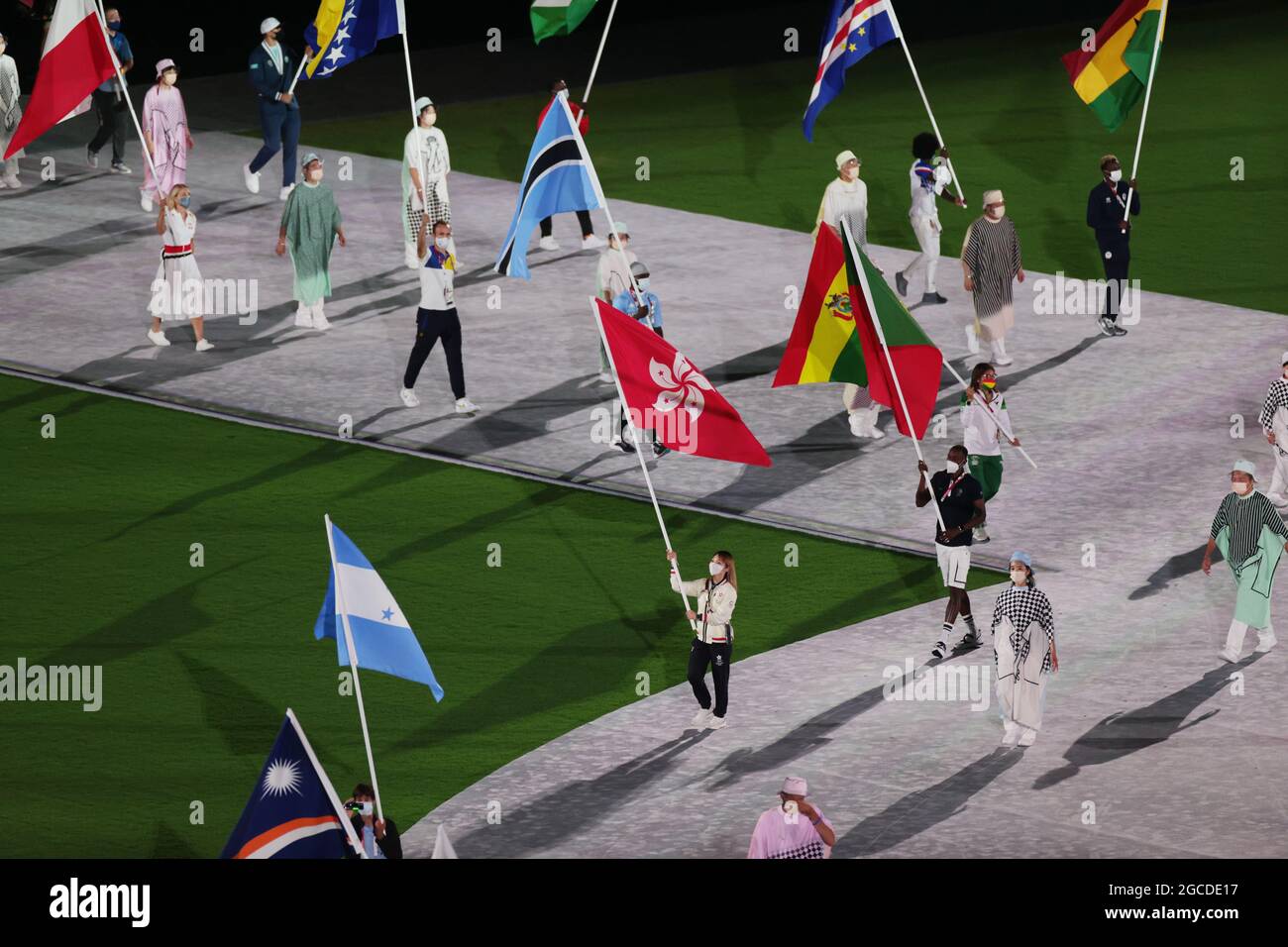 Tokyo, Japan. 8th Aug, 2021. Flag bearers carry flags into the Olympic