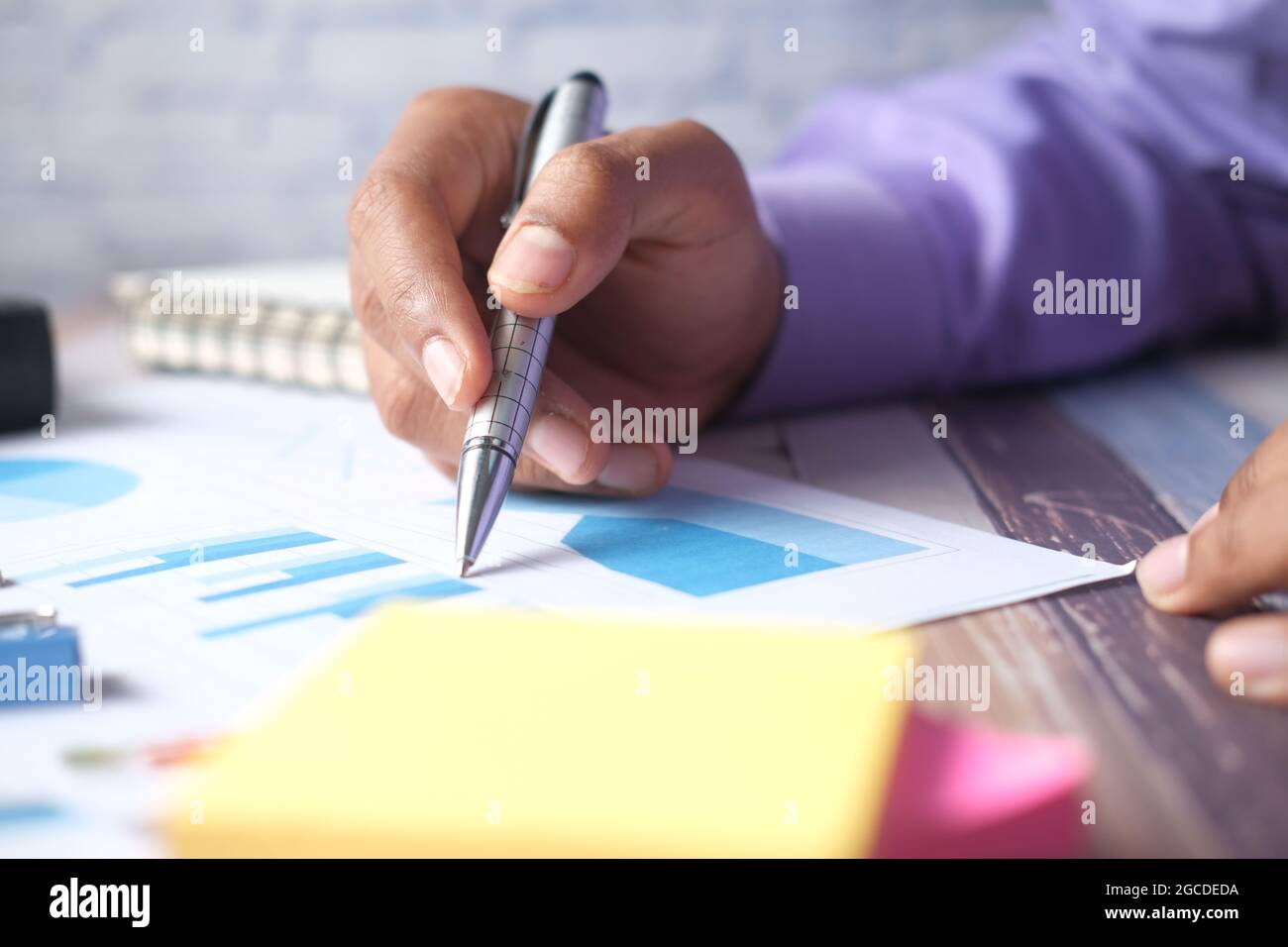 man hand with pen analyzing bar chart on paper Stock Photo - Alamy