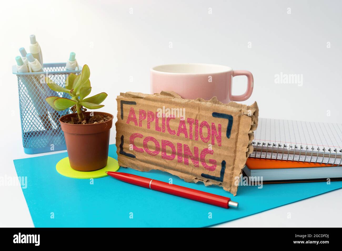 Handwriting text Application Coding. Concept meaning process by which a mobile app is developed for mobile Tidy Workspace Setup Writing Desk Tools And Stock Photo