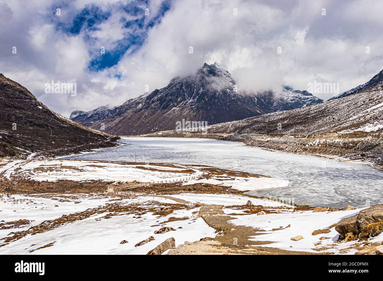 snow cap mountains with frozen lake and bright blue sky at morning from flat angle image is taken at sela tawang arunachal pradesh india. Stock Photo