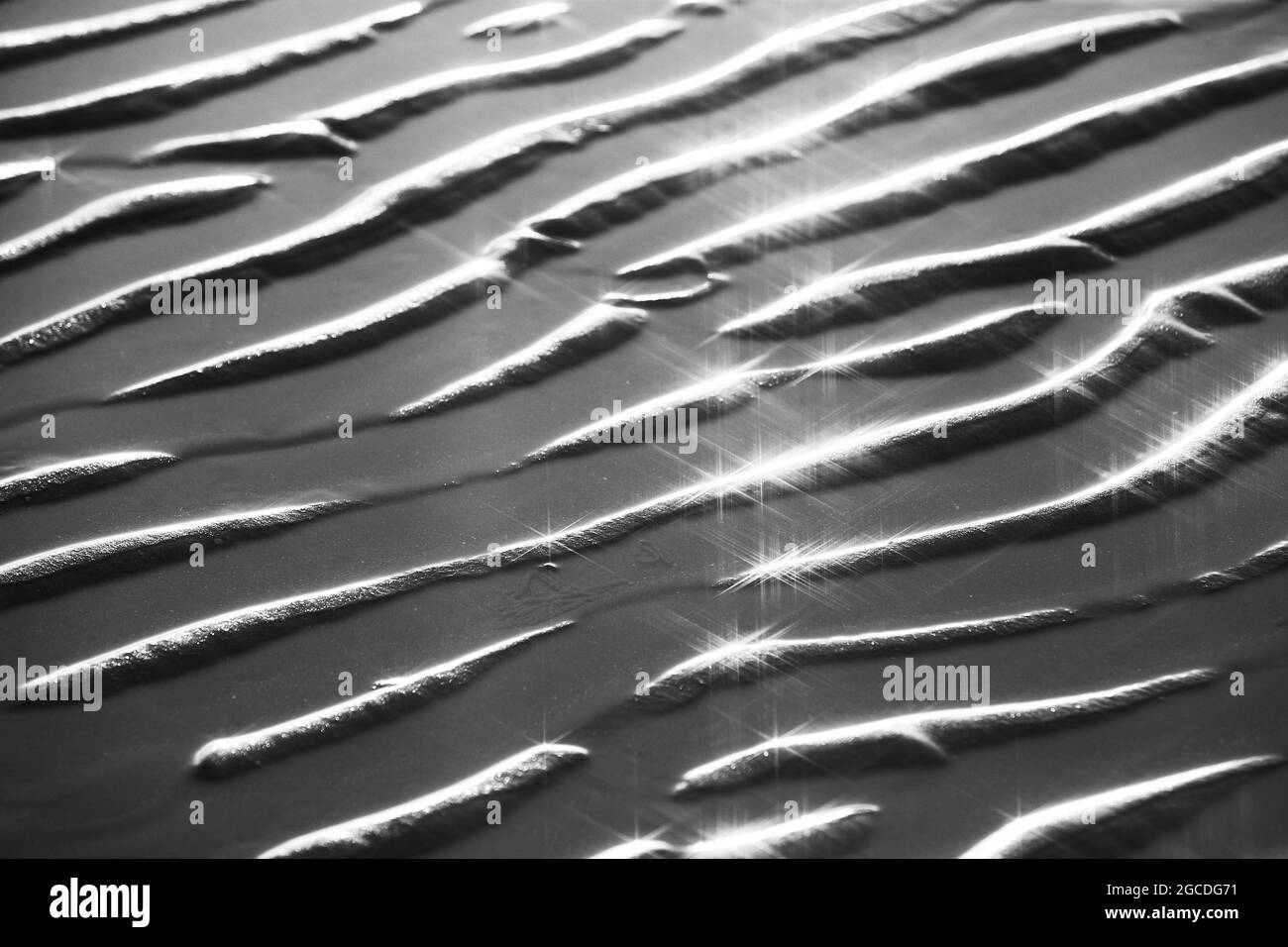 Texture of glitter water and soft waves. sparkling in water - background. sea water with sun glare and ripple. Powerful and peaceful nature concept. Stock Photo