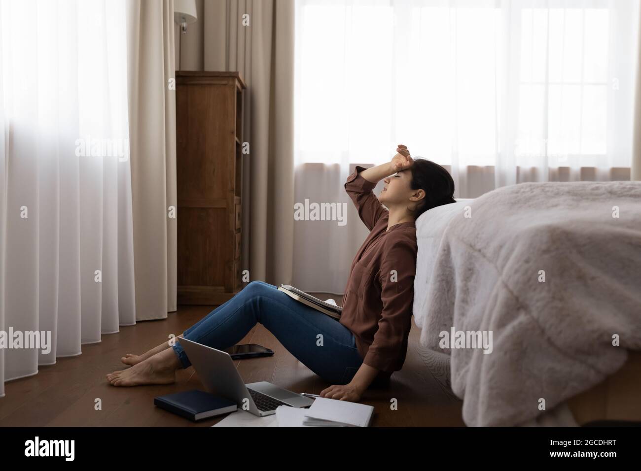 Tired Indian woman distressed studying on computer Stock Photo - Alamy