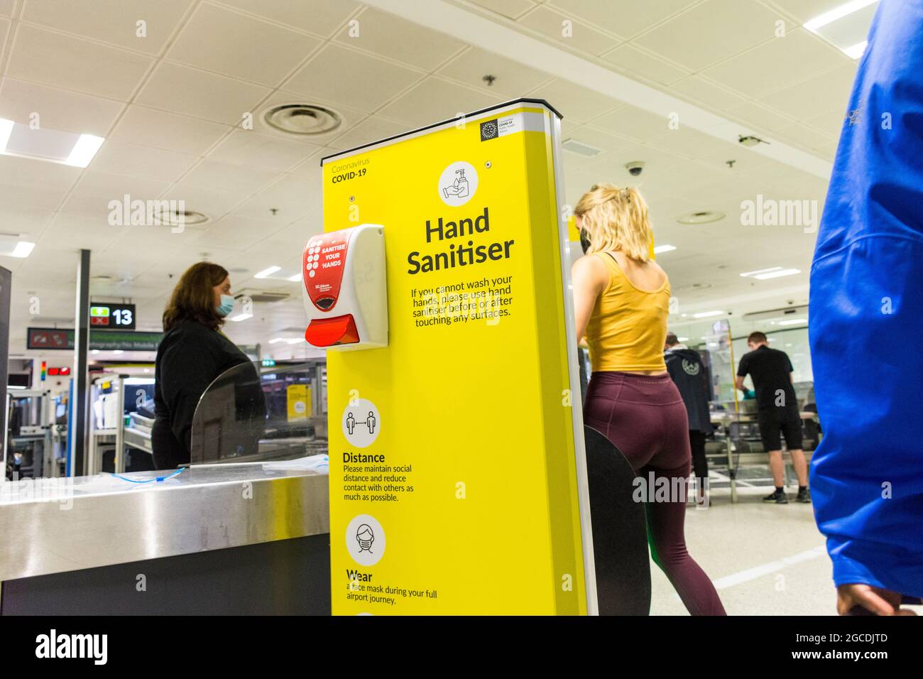 Dublin Airport departures security, Terminal One, Ireland. Masks wearing and hand sanitiser unit during Covid19 pandemic. Stock Photo