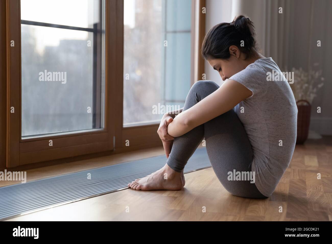 Unhappy Indian woman feel distressed at home Stock Photo