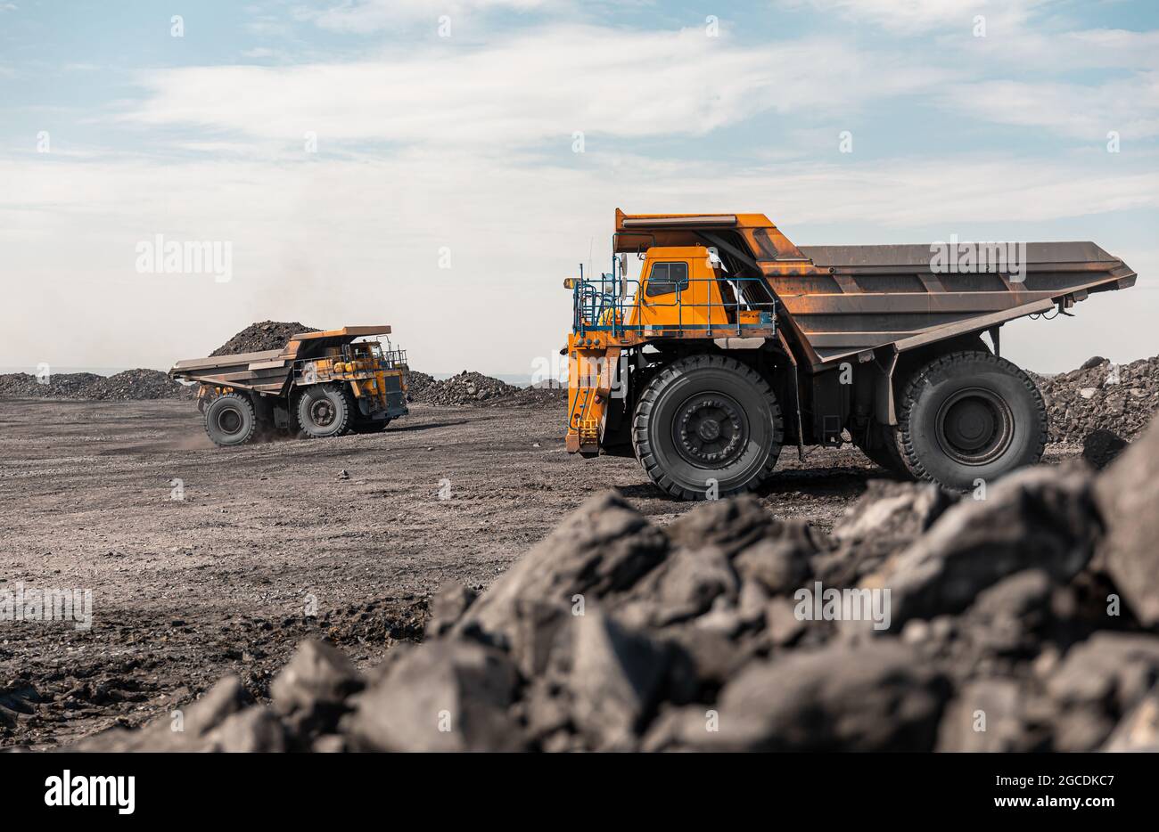 Large quarry dump truck. Big yellow mining truck at work site. Loading
