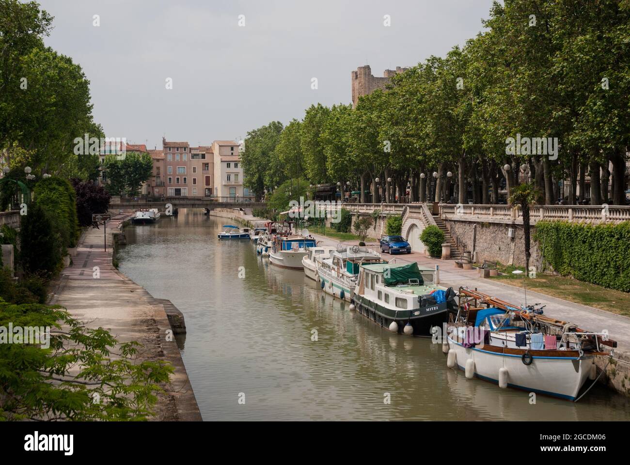 Boats on the Canal de la Robine in the historic city centre of Narbonne. Stock Photo