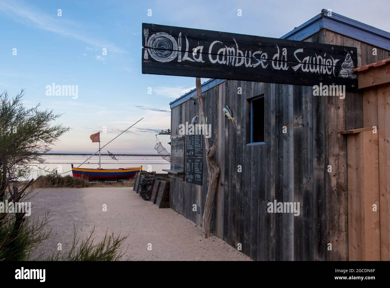 The restaurant at the salt ponds: evening mood at the Gruissan saltworks Stock Photo