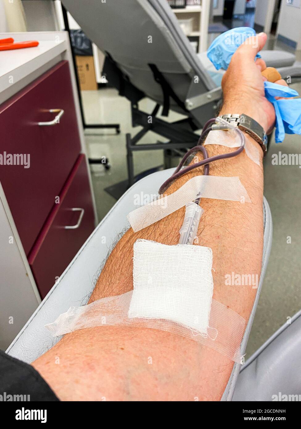 A man is in the process of donating blood to save a life. Stock Photo