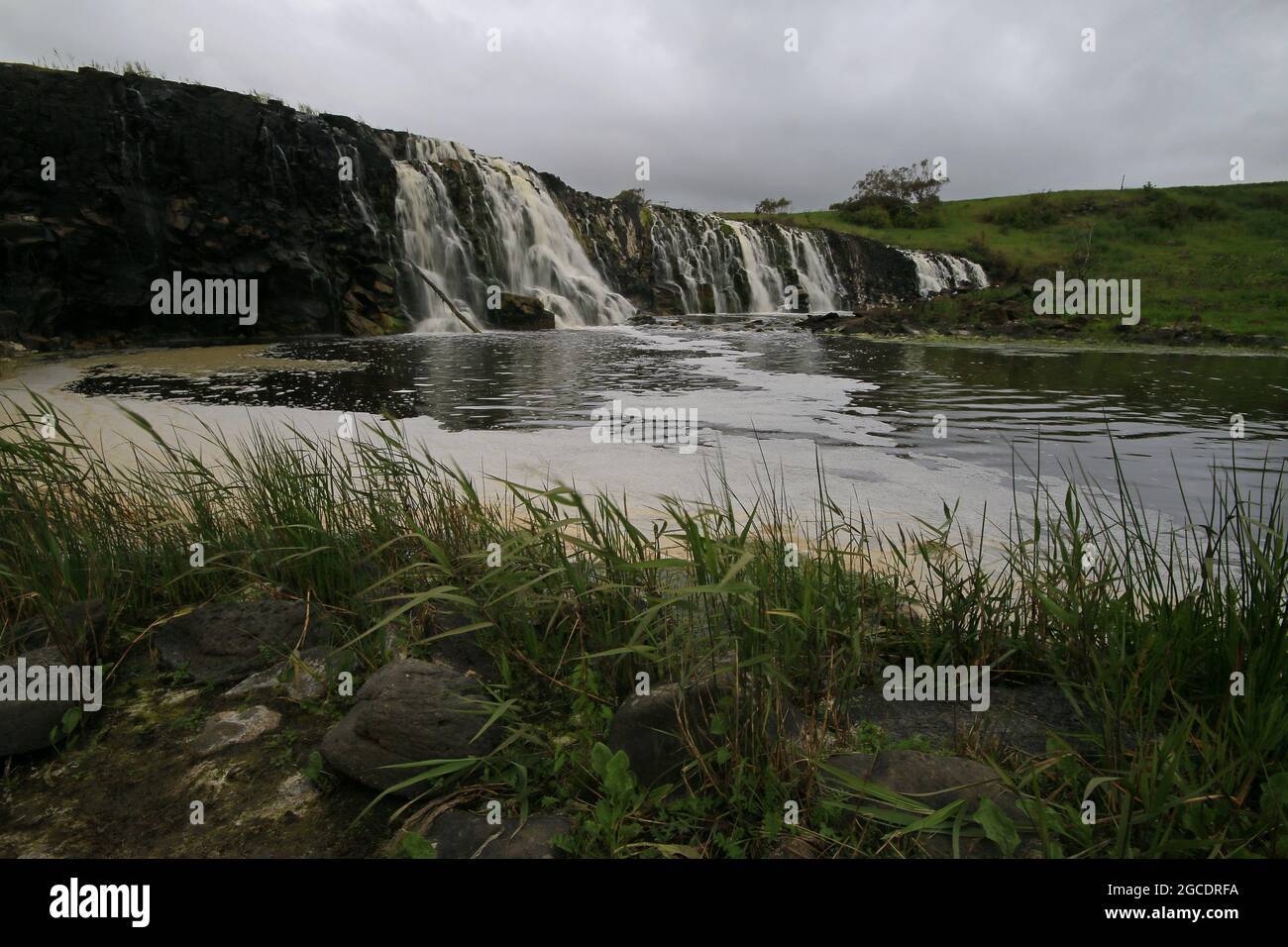 a large waterfall over a body of water Stock Photo