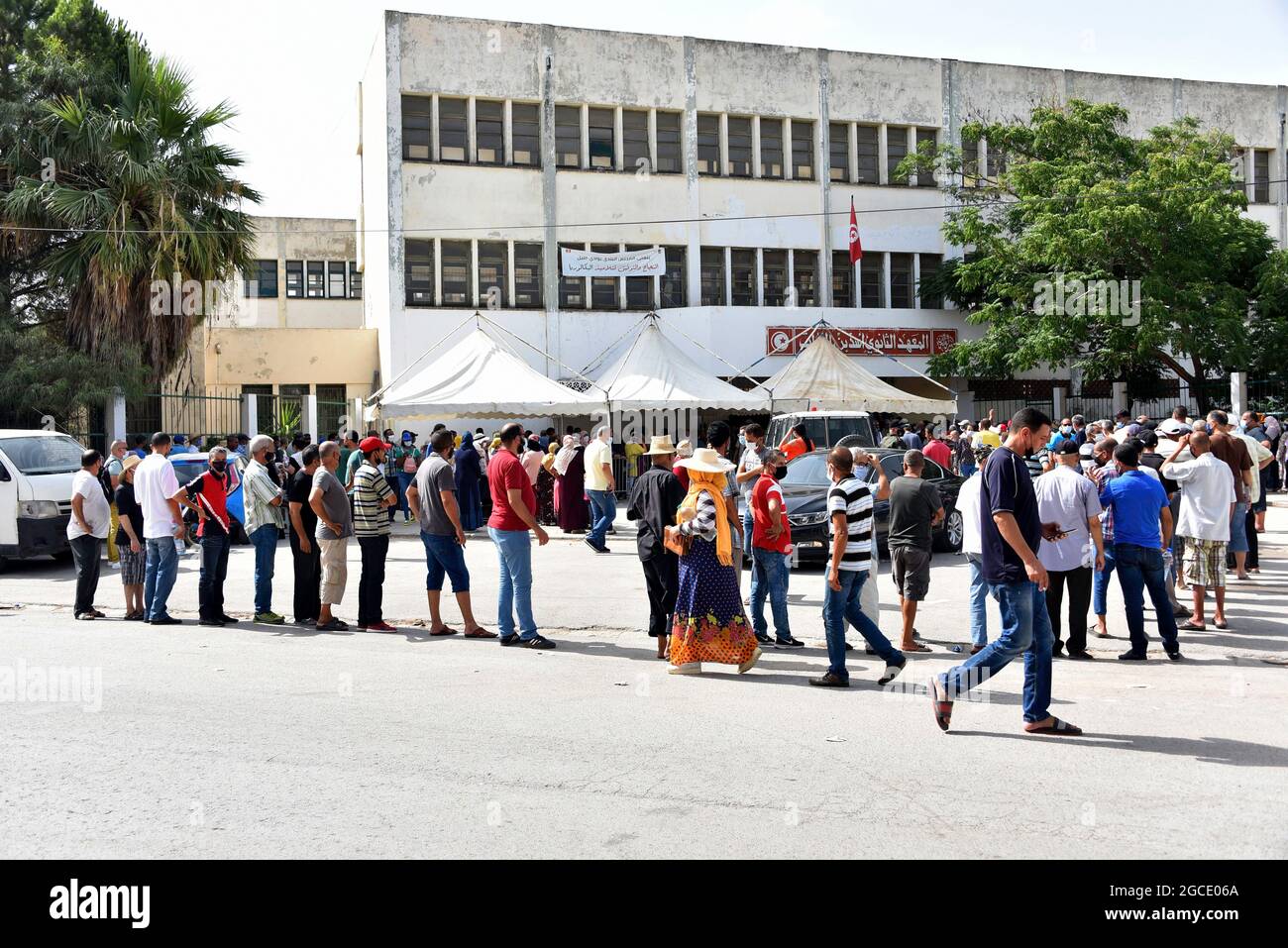 Tunis, Tunisia. 08th Aug, 2021. People queue up to receive a covid-19  vaccine at Oued Ellil high school in Manouba. The national Covid-19  vaccination day for people aged 40 and above started