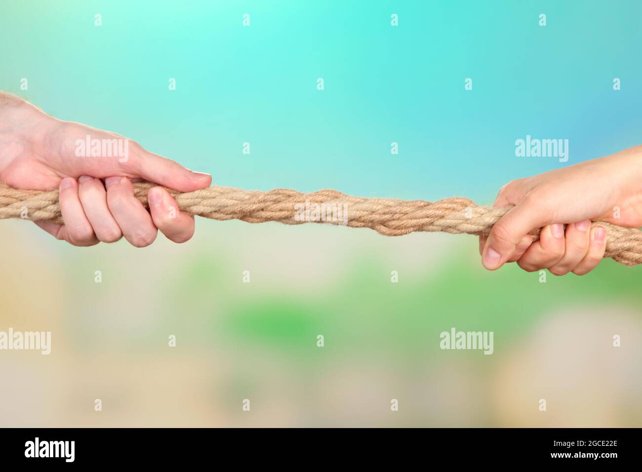 Tug of war, on bright background Stock Photo - Alamy