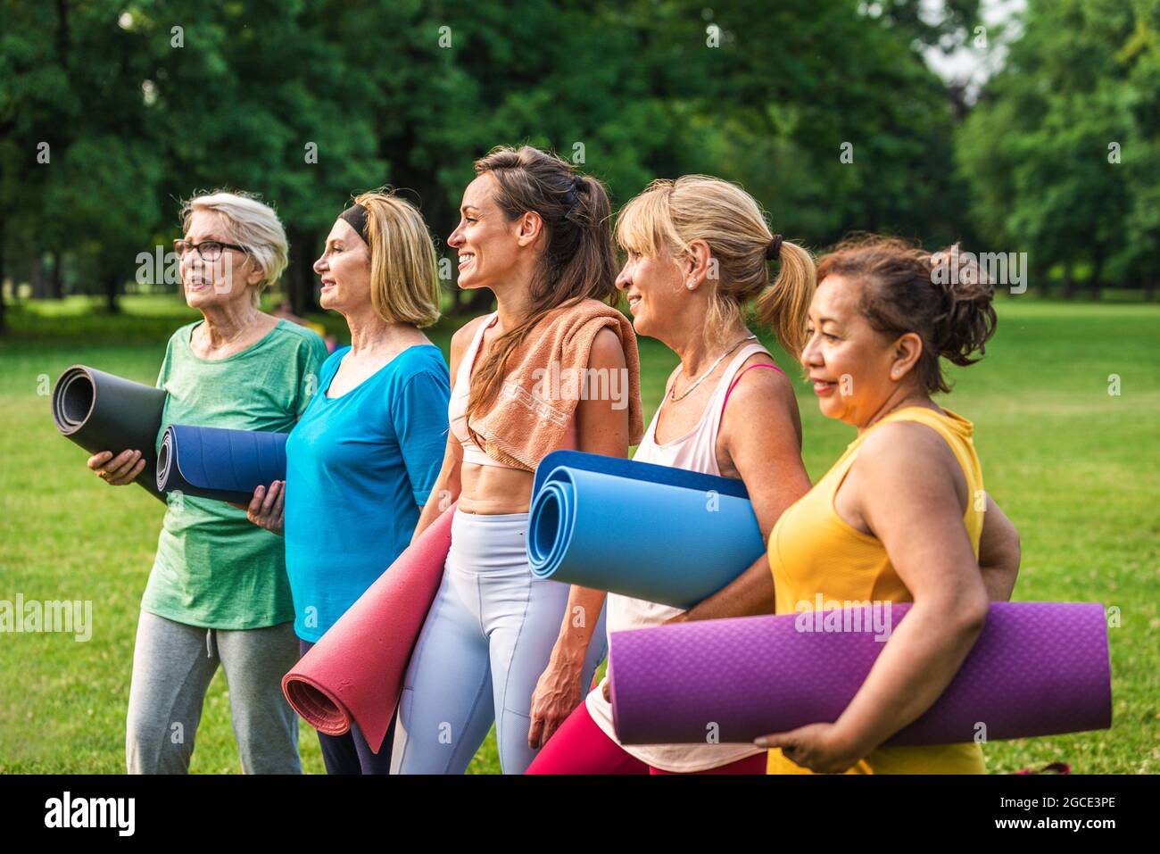 Group of middle aged women with fitness instructor in sportswear