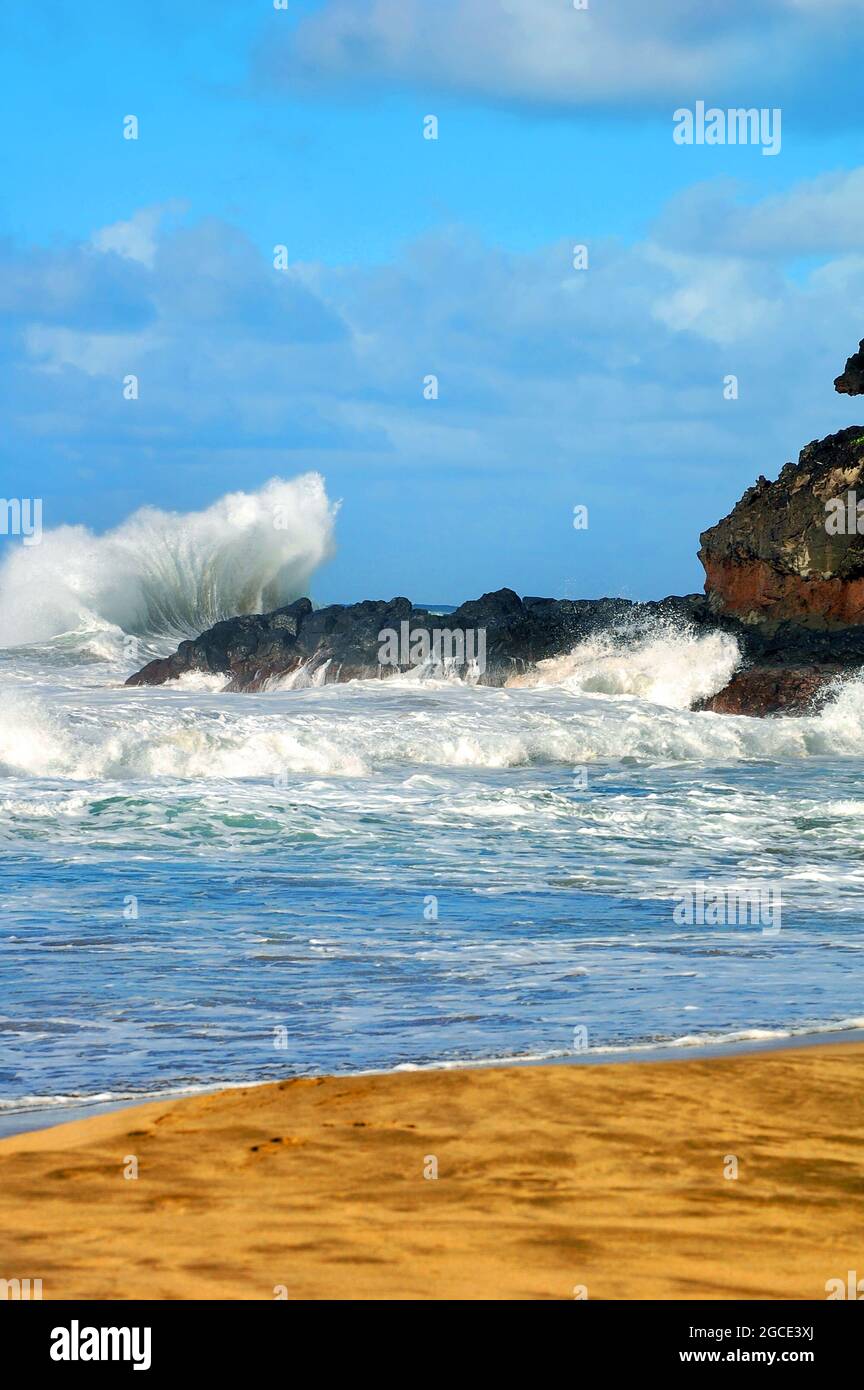 Big splash is created as a powerful wave hits the rocks on Lumaha'i