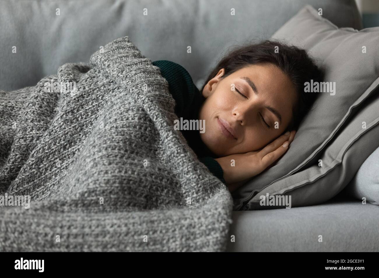 Close up peaceful woman with closed eyes resting on couch Stock Photo ...