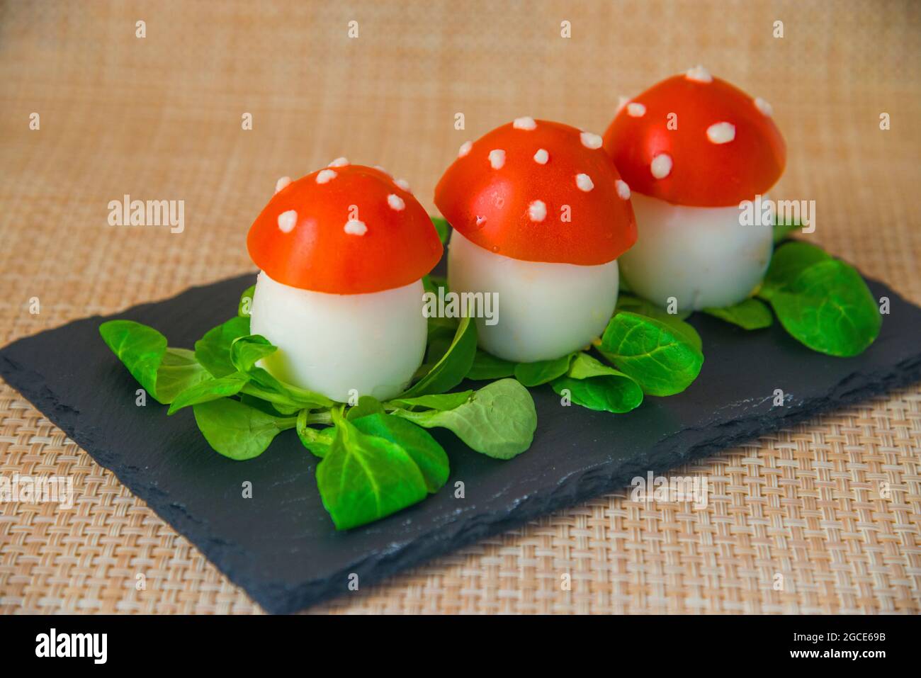 Pinchos made of boiled egg and tomato as mushrooms. Spain. Stock Photo