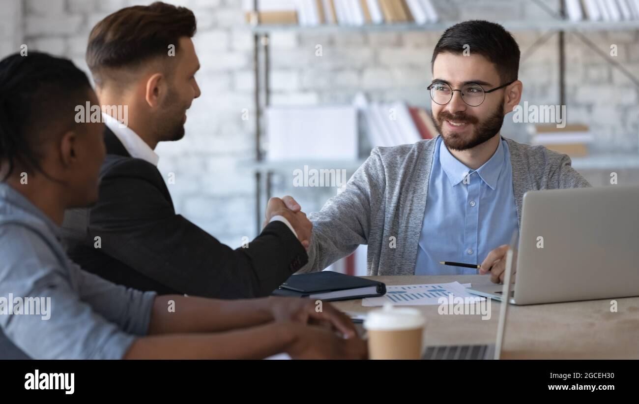 Smiling businesspeople handshake get acquainted in office Stock Photo