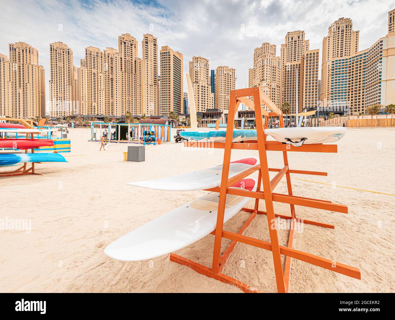 Stand with surf and sup boards for rent and swimming in the sea at JBR