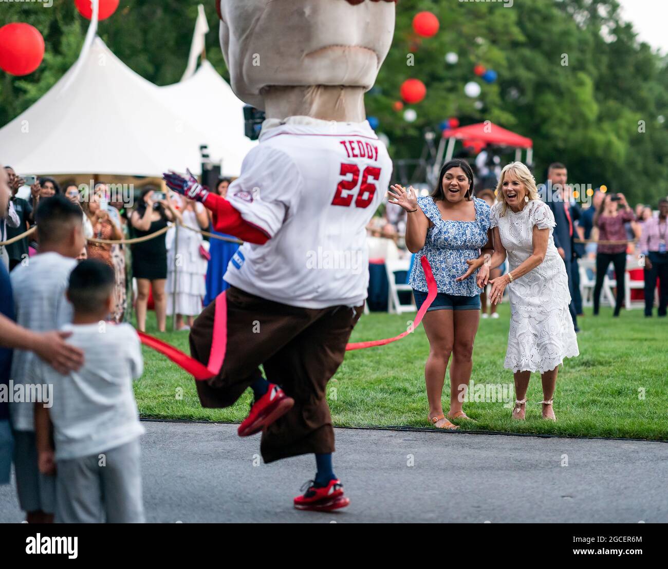 First Lady Jill Biden holds the finish line tape as the Washington Nationals’ Racing Presidents race on the South Lawn Driveway of the White House, Sunday, July 4, 2021, during the Fourth of July celebration. (Official White House Photo by Adam Schultz) Stock Photo