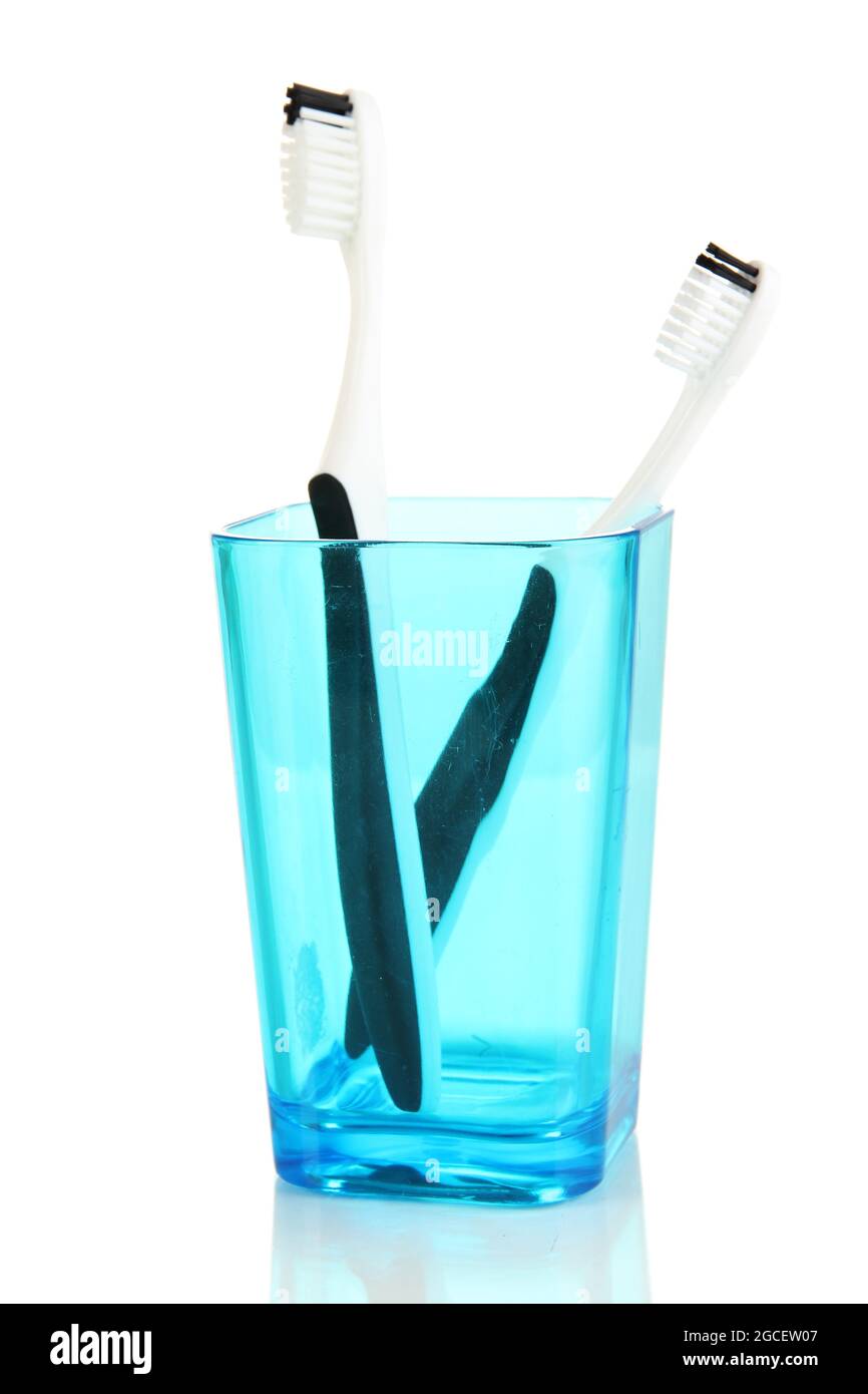 Tooth-brushes in glass isolated on white Stock Photo - Alamy