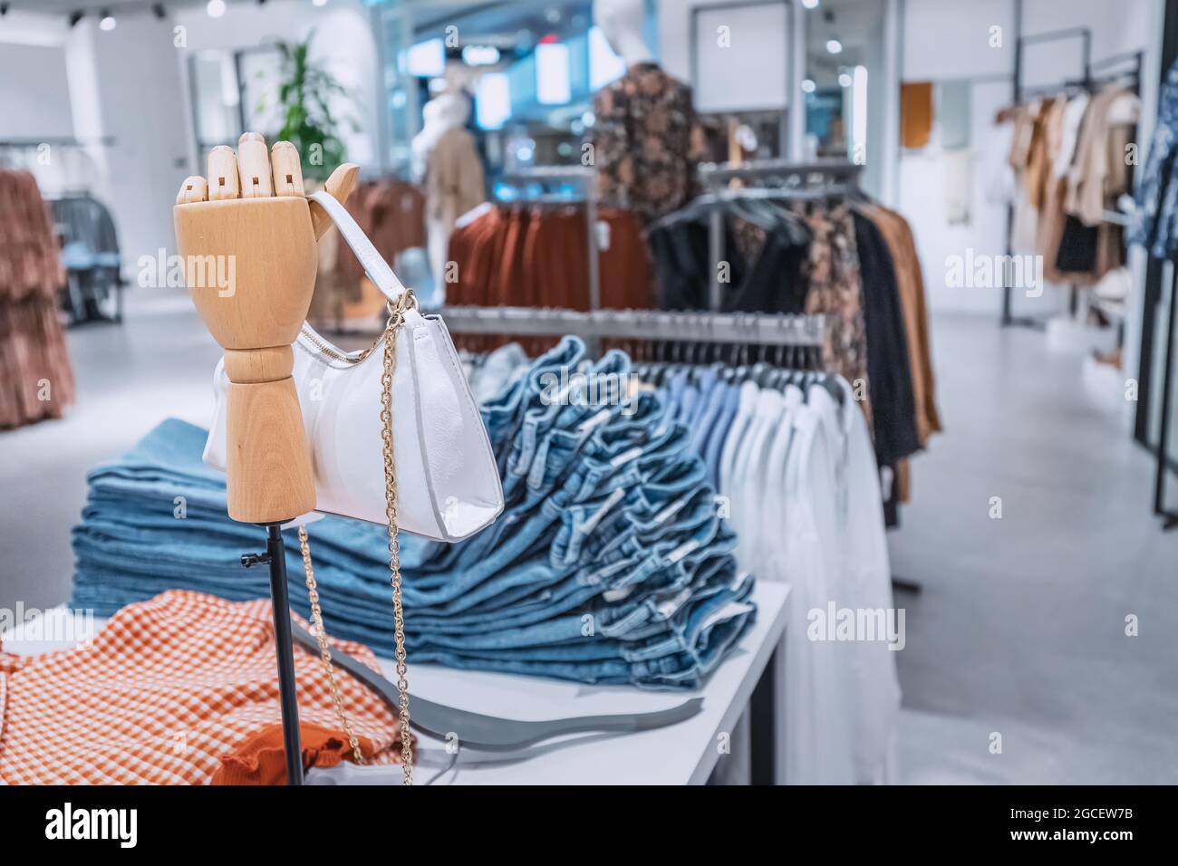 Department of casual fashion clothing the outlet in the shopping center. Stylish leather handbag on a wooden mannequin Stock Photo - Alamy