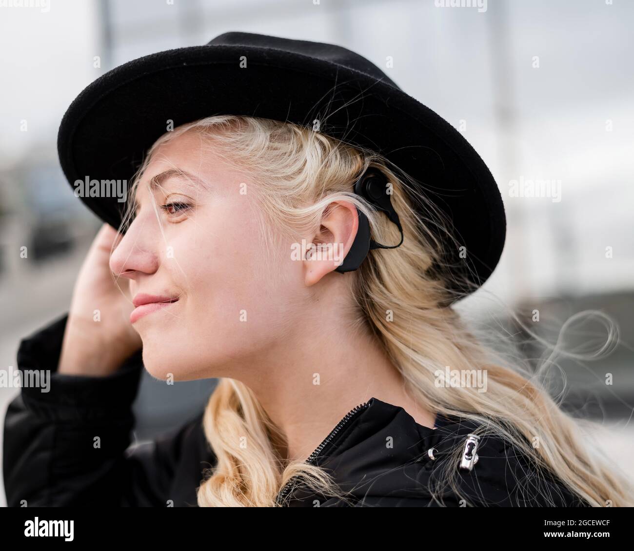 Portrait Of A Blonde Woman Wearing A Hearing Aid Stock Photo Alamy