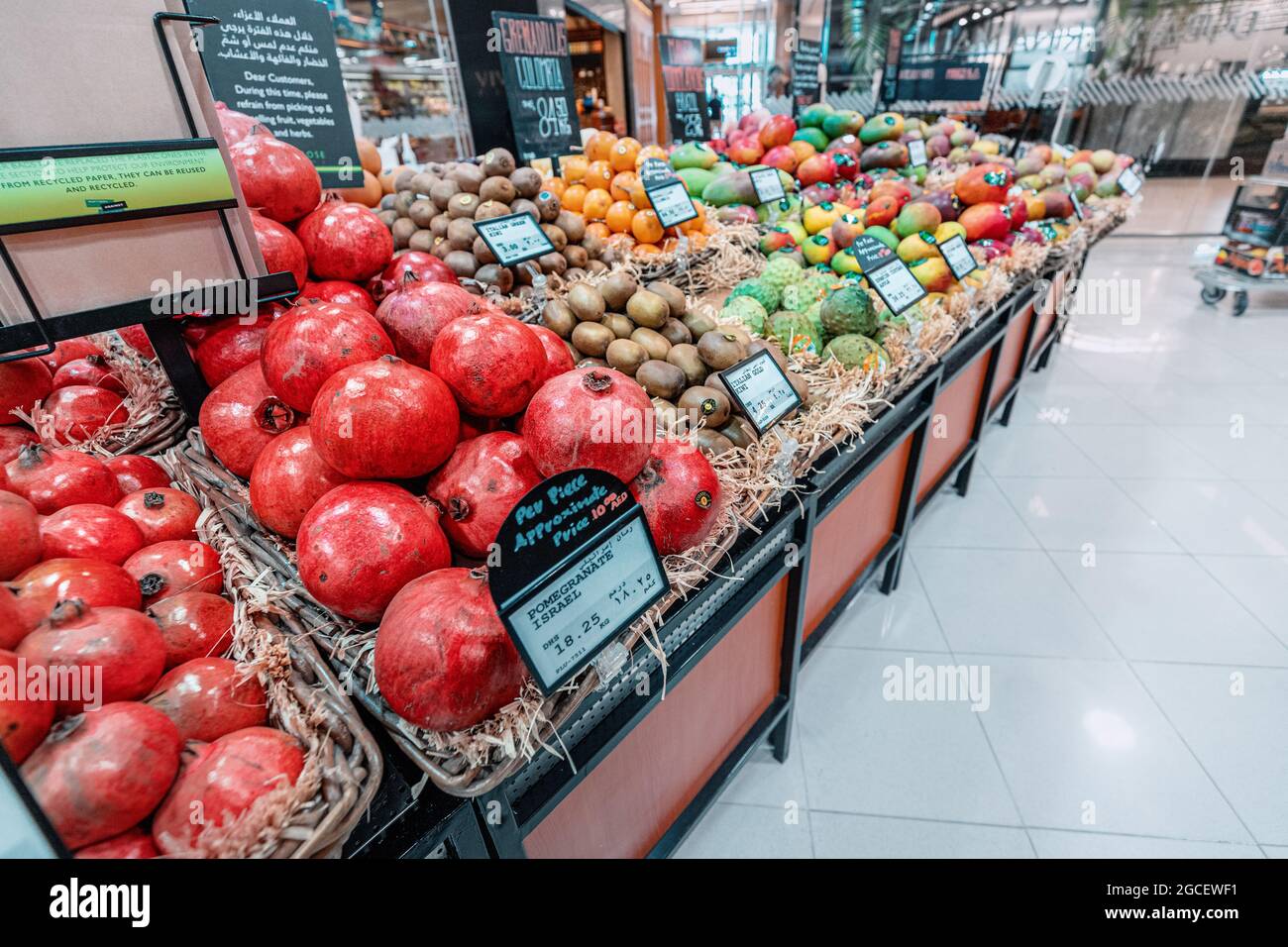 23 February 2021, Dubai, UAE: Ripe Pomegranate from Israel with a price tag in dirhams is sold in a supermarket in Dubai Stock Photo