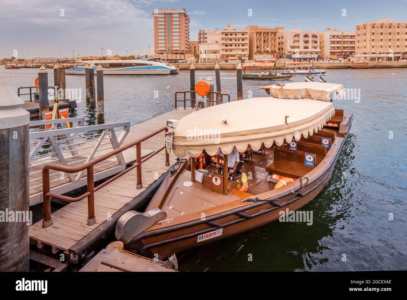 23 February 2021, Dubai, UAE: Abra ferry boat moored at the pier at public transport station of RTA at Dubai Creek Stock Photo