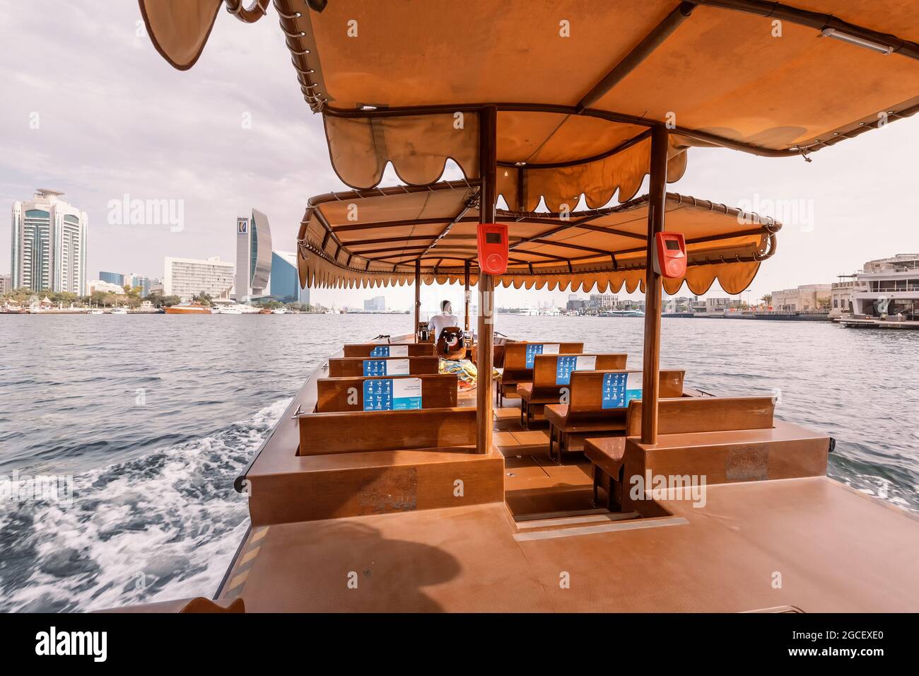 23 February 2021, Dubai, UAE: Empty ferry boat with no passengers cruising between the banks of the Dubai Creek Canal. Public transportation Stock Photo