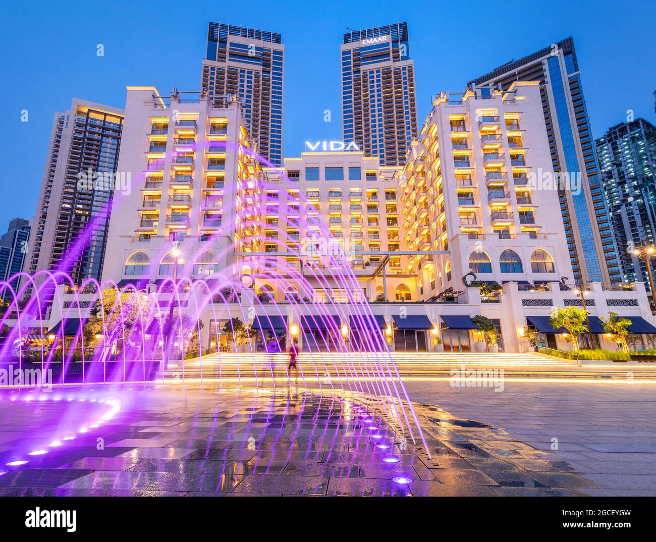 24 February 2021, Dubai, UAE: Vida hotel and illuminated fountain panoramic view in Dubai Marina Creek Harbour Stock Photo