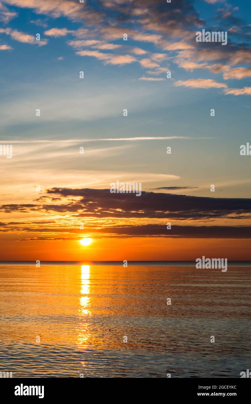 Sunset over the sea. Red and yellow sky in the rays of the sunset ...