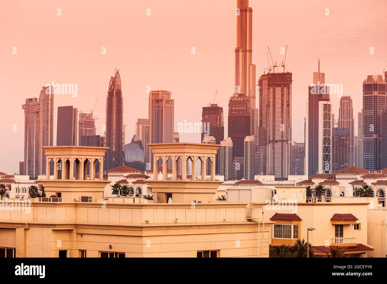 Suburb of Dubai with private residential buildings against the backdrop of a downtown metropolis with skyscrapers and hotels Stock Photo
