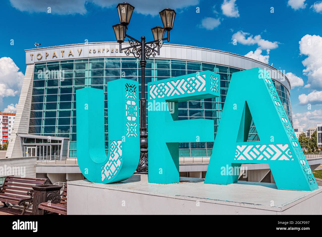 09 June 2021, Ufa, Russia: Name of the capital of the Republic of Bashkortostan on the background of the Congress Hall building. Tourist attractions Stock Photo