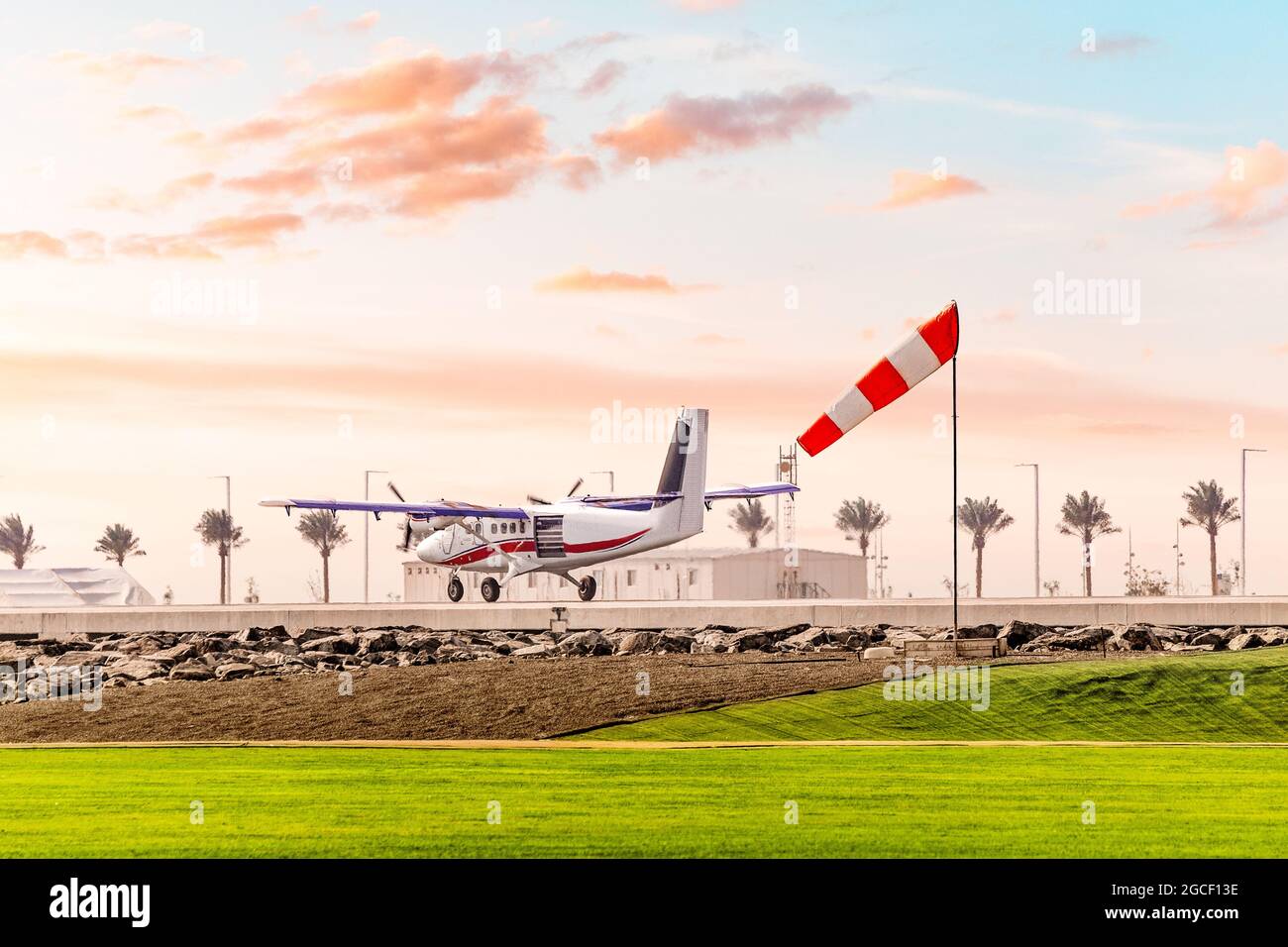 The wind sock shows the speed and shear at the airfield during the takeoff of a light twin engine aircraft Stock Photo