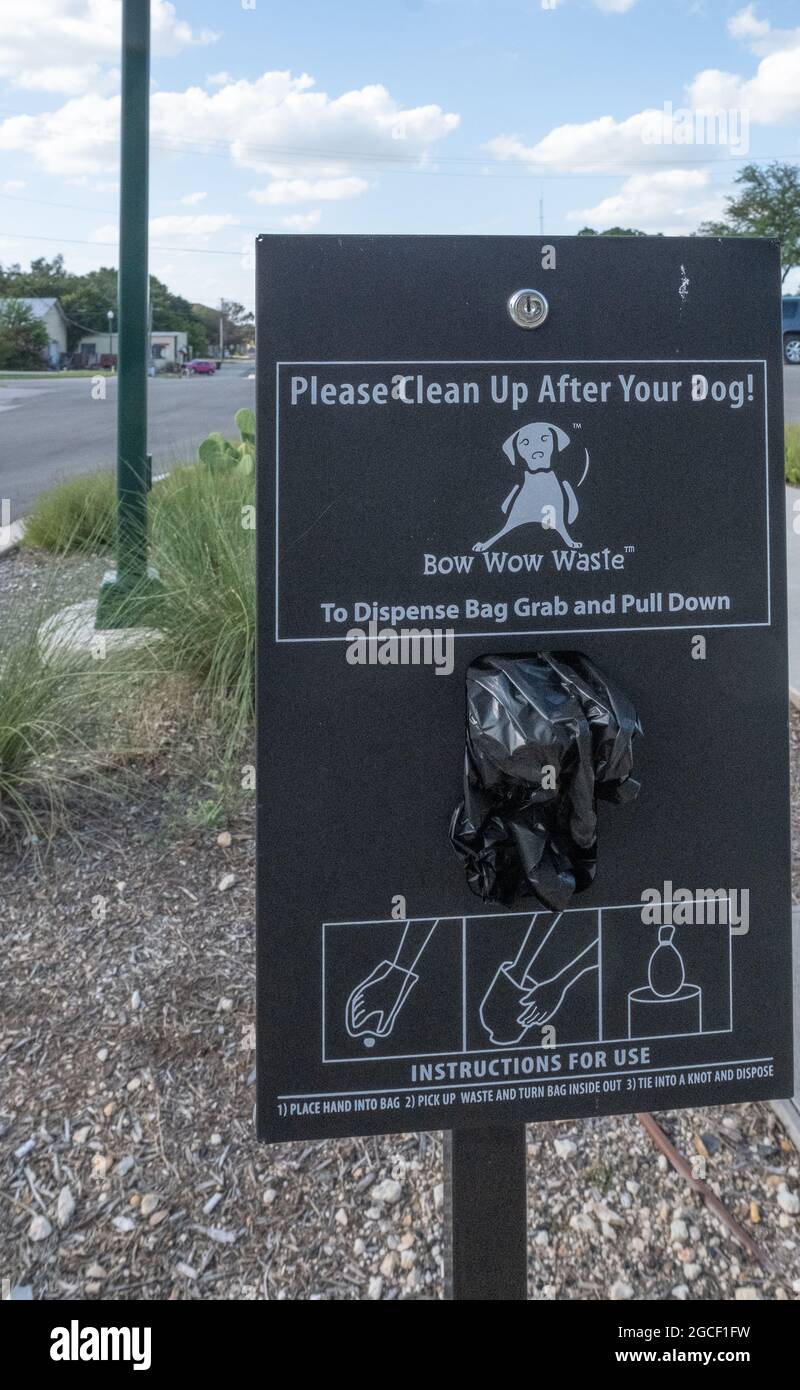 Sign and dispenser for bags to clean up dog waste Georgetown, Texas USA Stock Photo