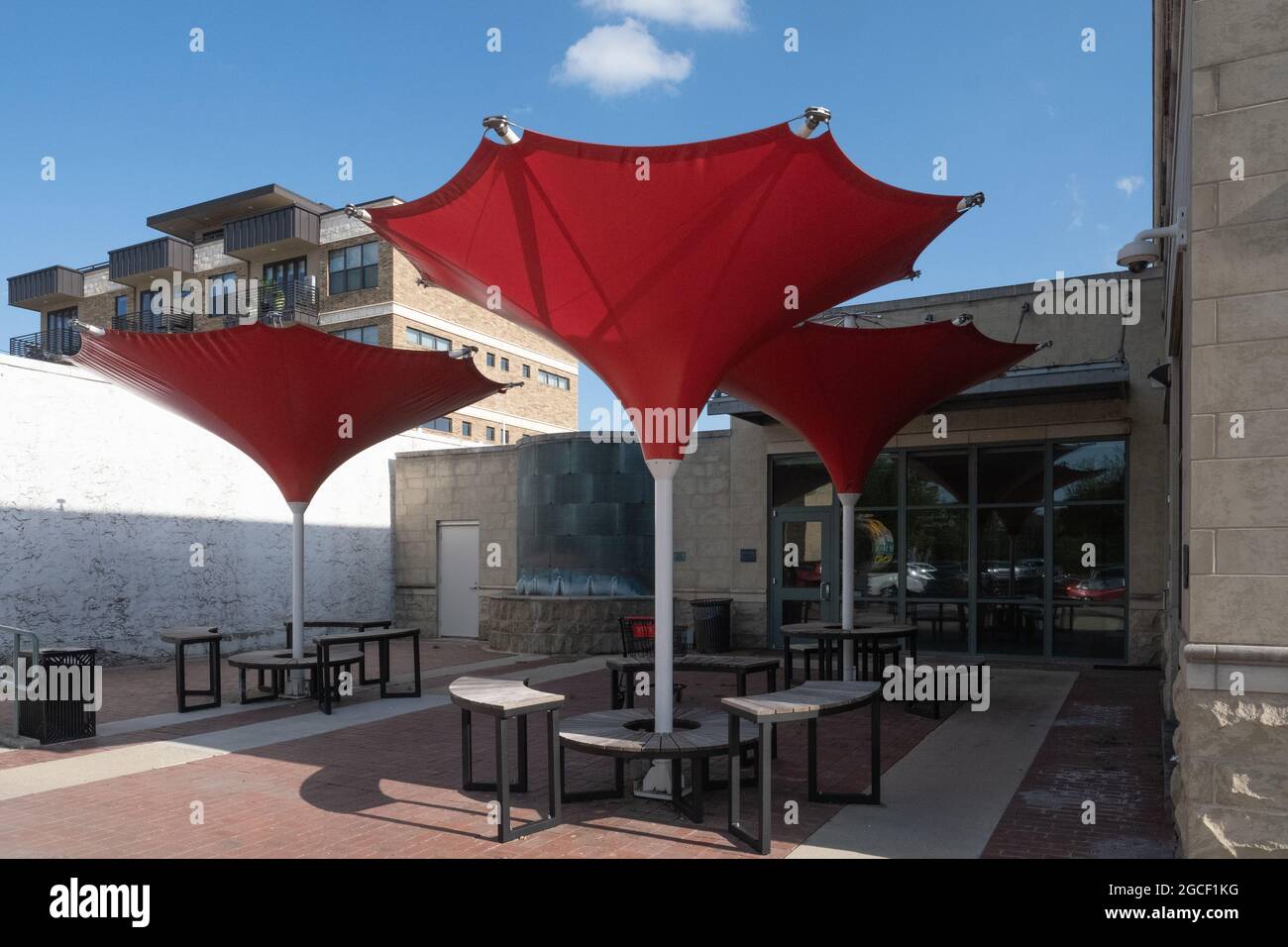 Sunshades for outside seating benches in shape of large red inverted umbrellas Georgetown, Texas USA Stock Photo