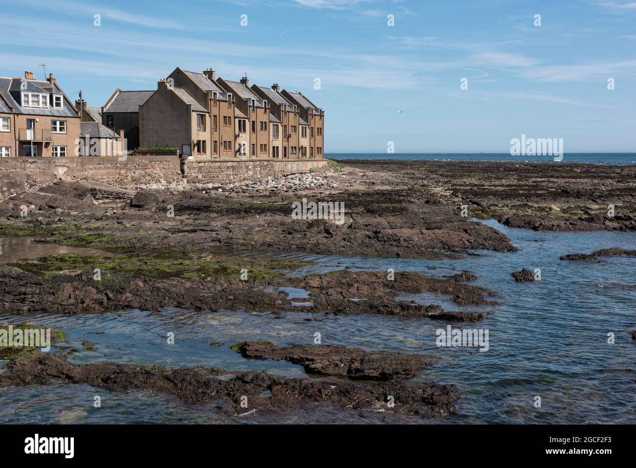 Houses right by the foreshore in the fishing village of Gourdon, Aberdeenshire, Scotland. Stock Photo