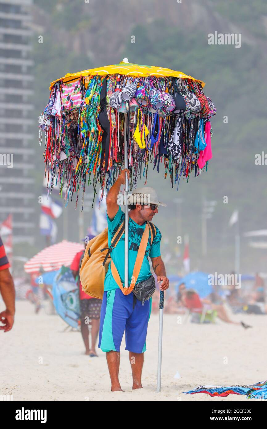 R, BRAZIL - Dec 06, 2017: A vertical shot of male selling swimsuits on ...