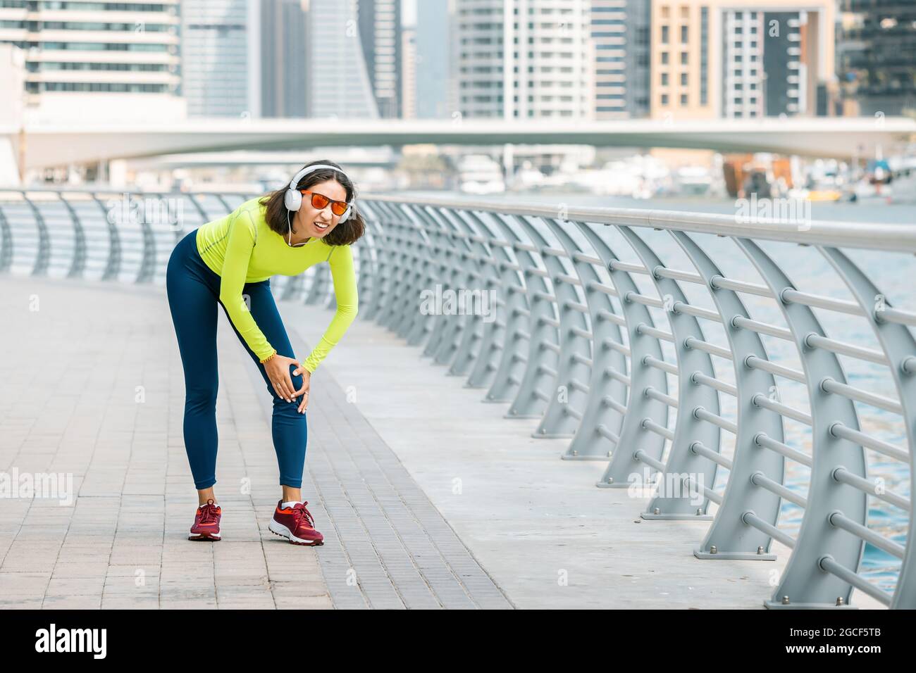 Young woman was running along the embankment and suddenly felt a sharp
