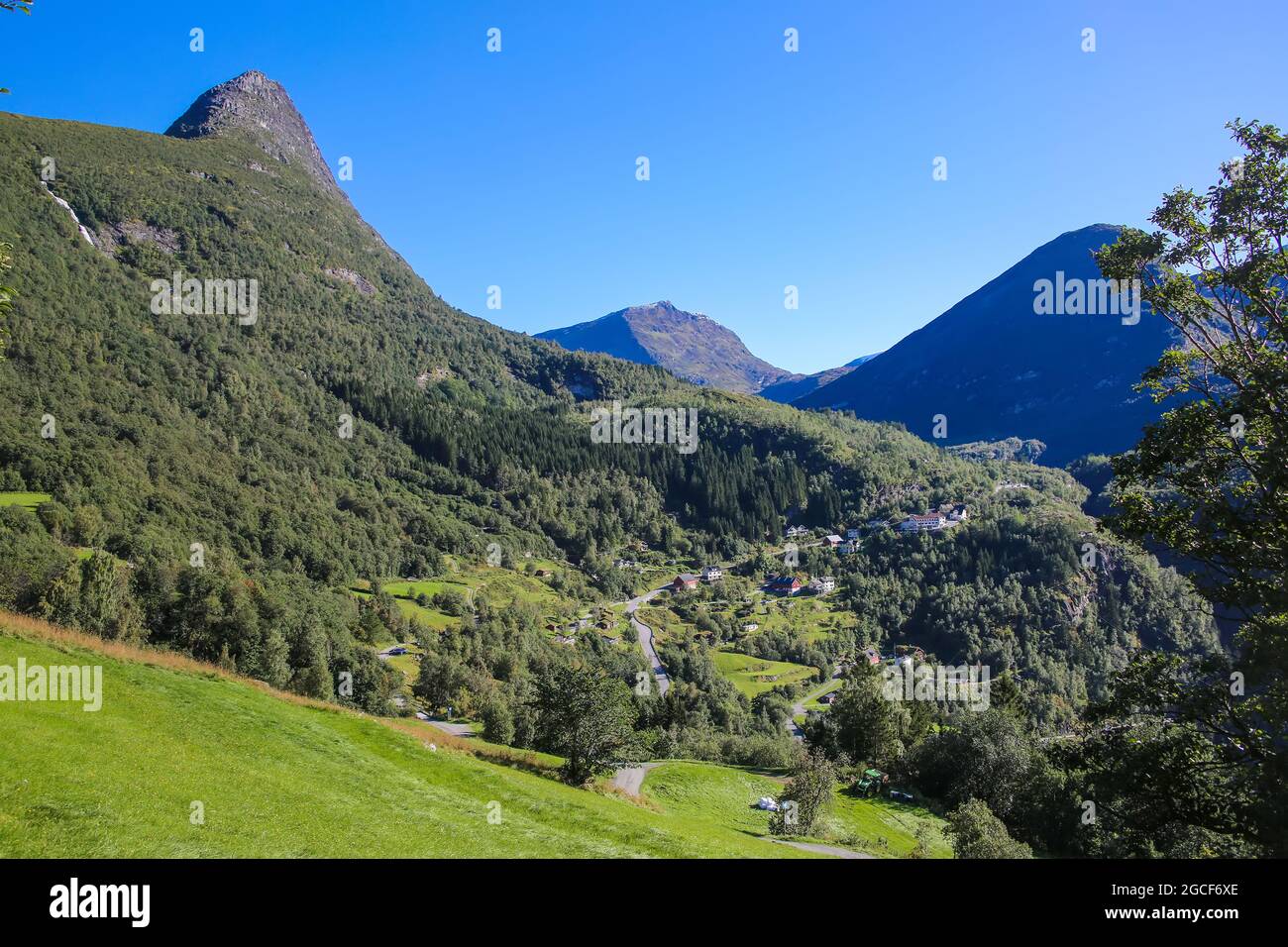 Beautiful views from Fosseråsa hiking trail of mountains, Villages and valley landscape close to Geiranger fjord, Norway. Summers day with  blue sky. Stock Photo